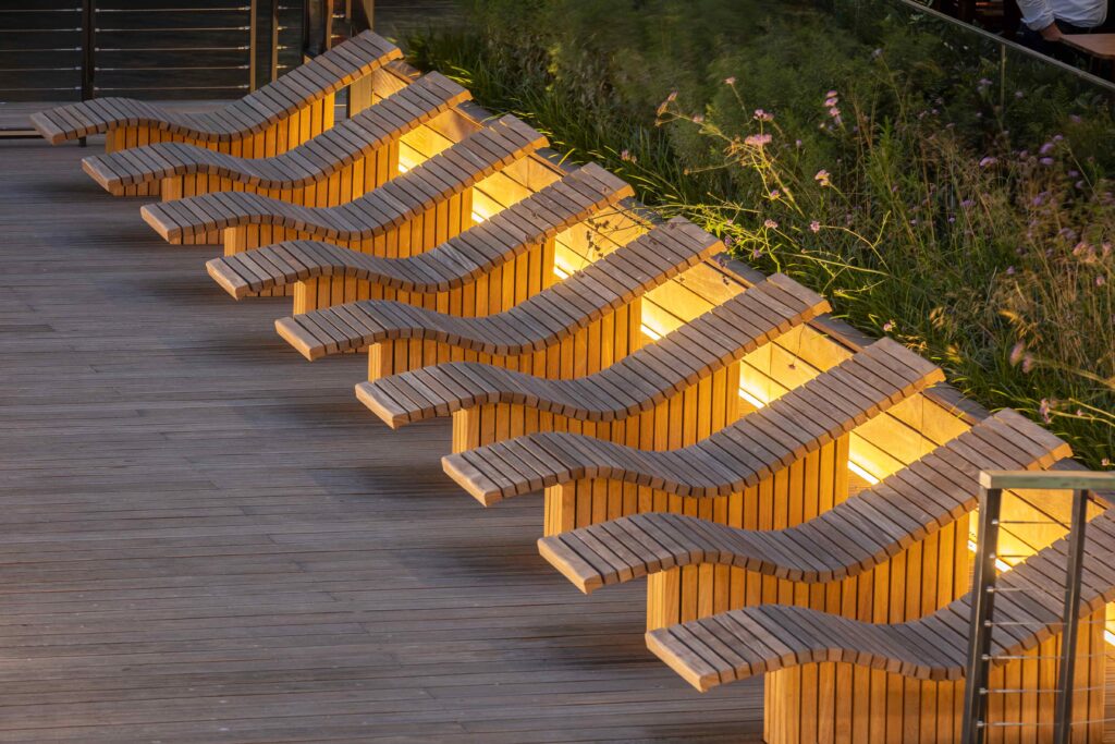 sun loungers at water pavillion in canary wharf at night